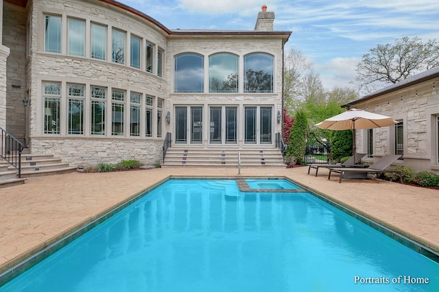 back of house with a pool with hot tub and a patio