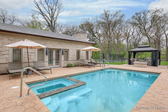 view of pool featuring a gazebo, a patio area, an in ground hot tub, and french doors