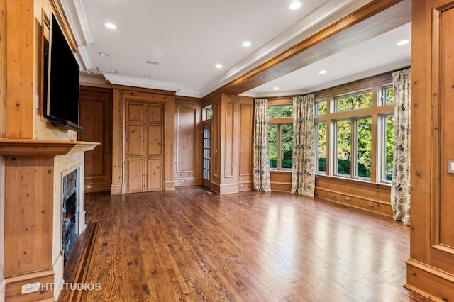 unfurnished living room with crown molding and dark hardwood / wood-style floors