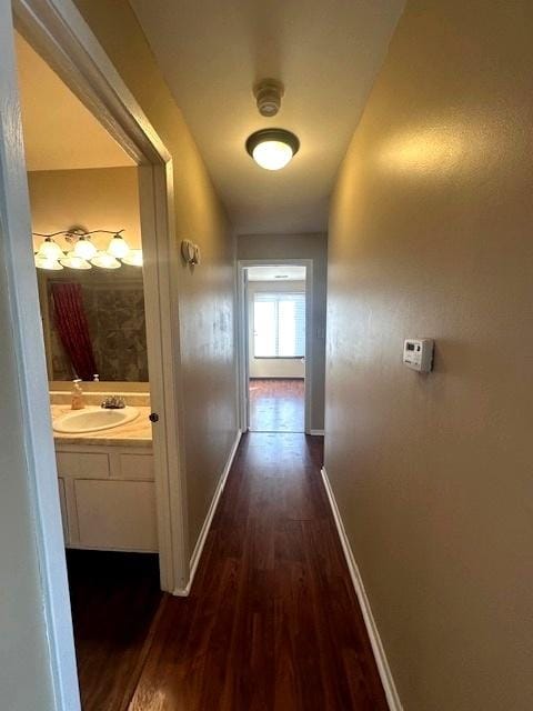 hallway featuring dark hardwood / wood-style flooring and sink