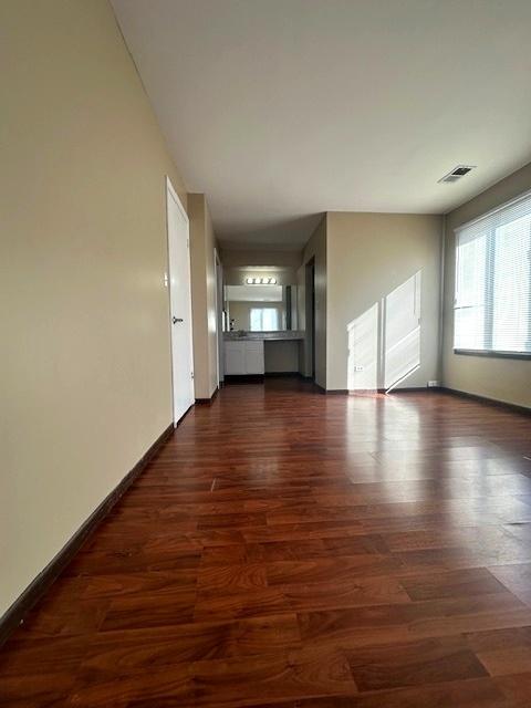 unfurnished living room featuring dark hardwood / wood-style floors