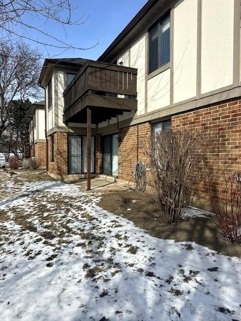 view of snow covered exterior with a balcony