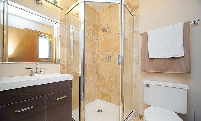 bathroom featuring walk in shower, vanity, and toilet