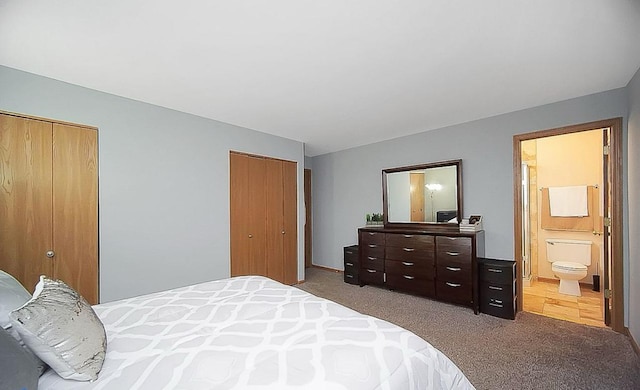 bedroom featuring light carpet and connected bathroom