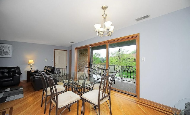 dining room featuring a chandelier and light hardwood / wood-style flooring