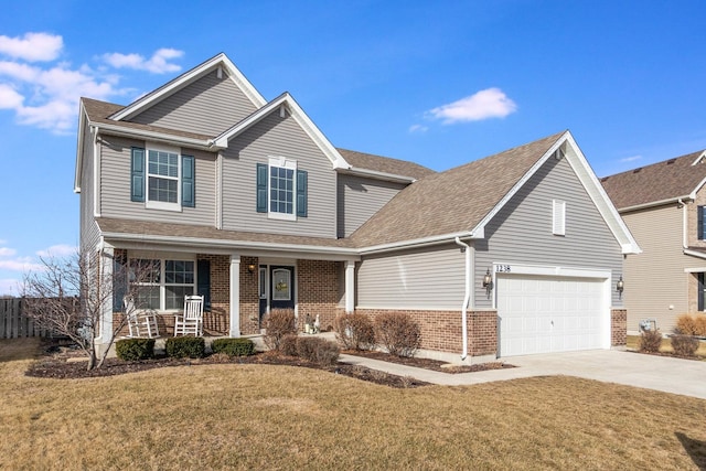 view of front of property featuring a porch, a garage, and a front lawn