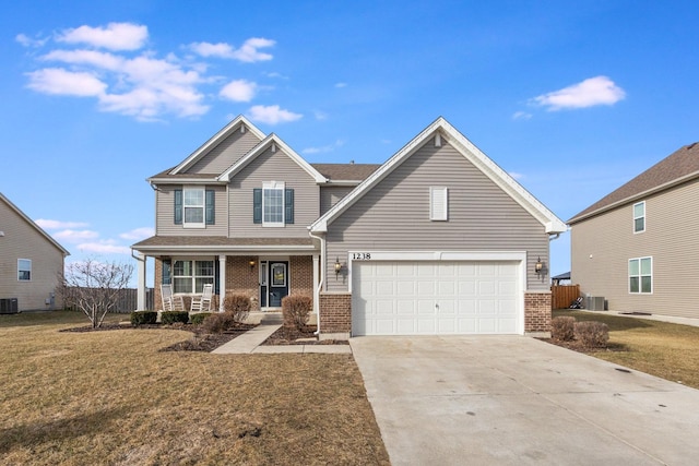 view of front of house featuring a porch, a garage, cooling unit, and a front lawn