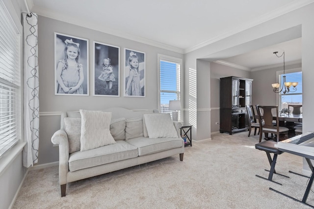 carpeted living room with plenty of natural light, ornamental molding, and a notable chandelier