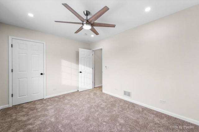 unfurnished bedroom with ceiling fan and light carpet