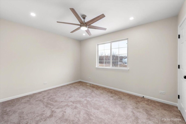 empty room featuring light carpet and ceiling fan