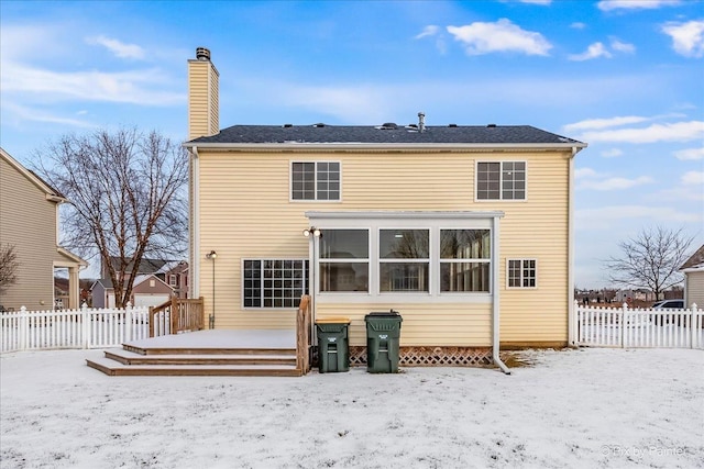 snow covered rear of property featuring a deck