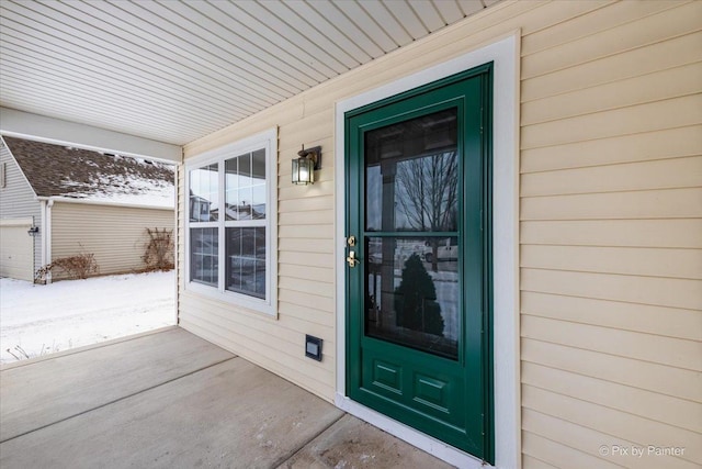 view of snow covered property entrance