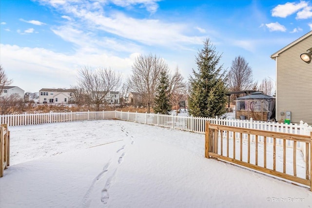 snowy yard with a gazebo