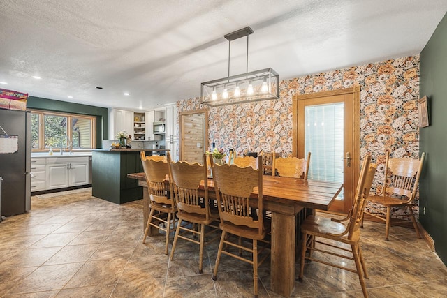 dining area featuring a textured ceiling