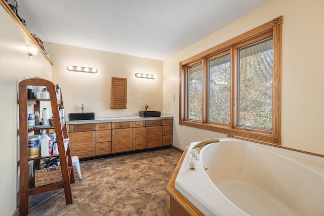 bathroom with vanity and a bathing tub