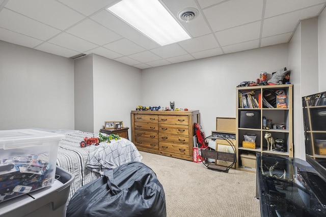 bedroom with a paneled ceiling and carpet flooring