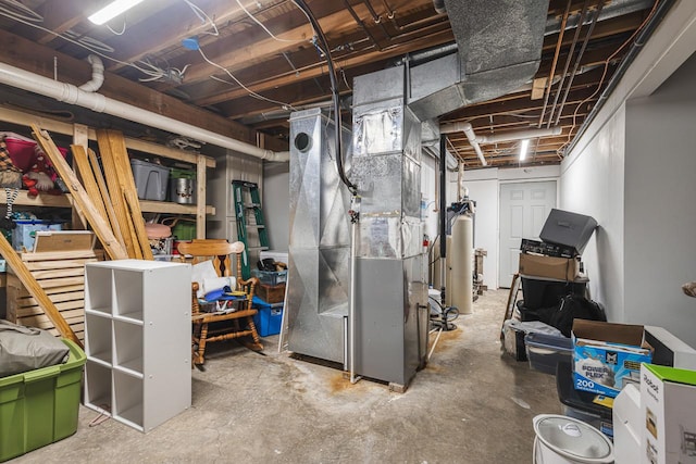 basement featuring heating unit and water heater