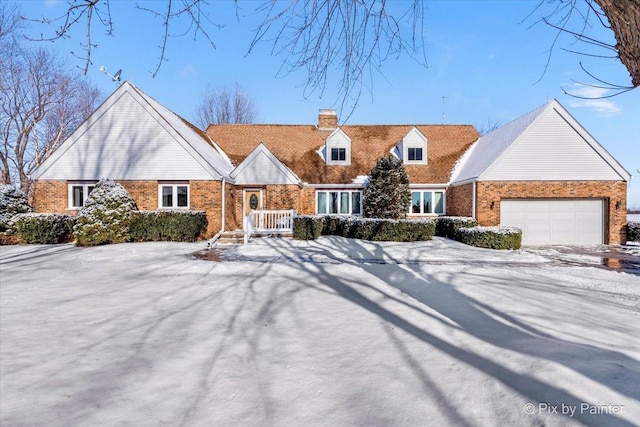 cape cod-style house featuring a garage