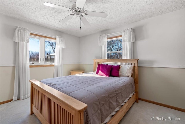 carpeted bedroom with a textured ceiling and ceiling fan