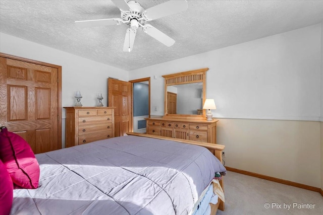 bedroom with light carpet, a textured ceiling, and ceiling fan