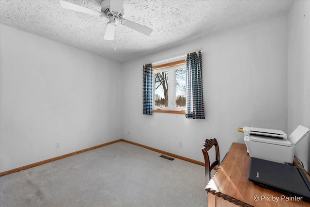 office with ceiling fan, carpet floors, and a textured ceiling