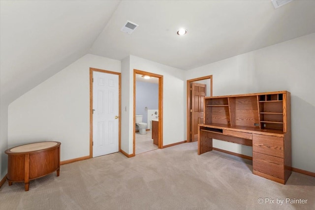 home office featuring light carpet and vaulted ceiling