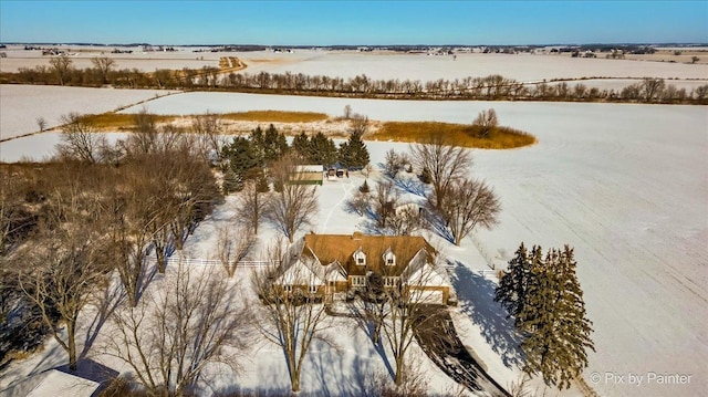 snowy aerial view featuring a rural view