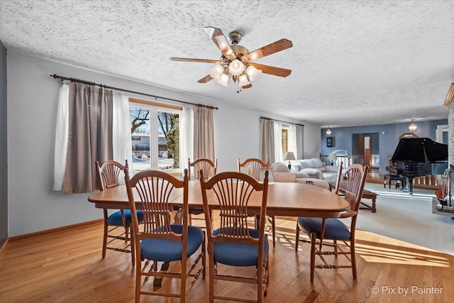 dining room featuring ceiling fan, a textured ceiling, and light hardwood / wood-style floors