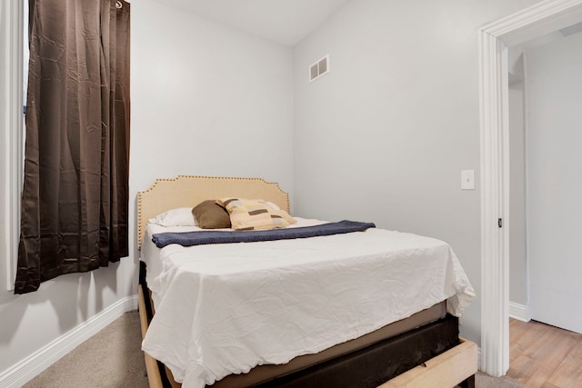 bedroom with hardwood / wood-style floors