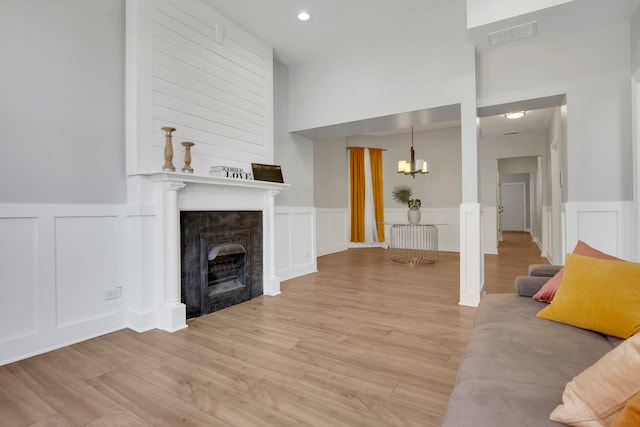 unfurnished living room featuring light hardwood / wood-style flooring and a chandelier