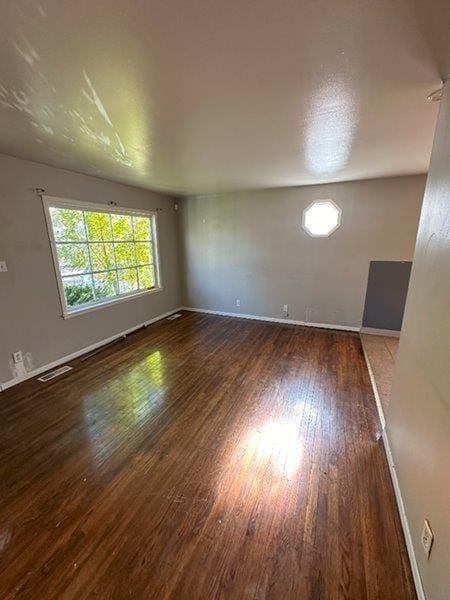 spare room featuring dark hardwood / wood-style flooring