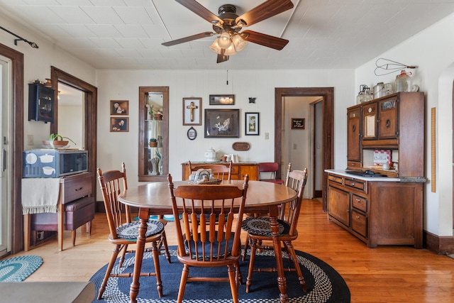 dining area featuring ceiling fan and light hardwood / wood-style floors