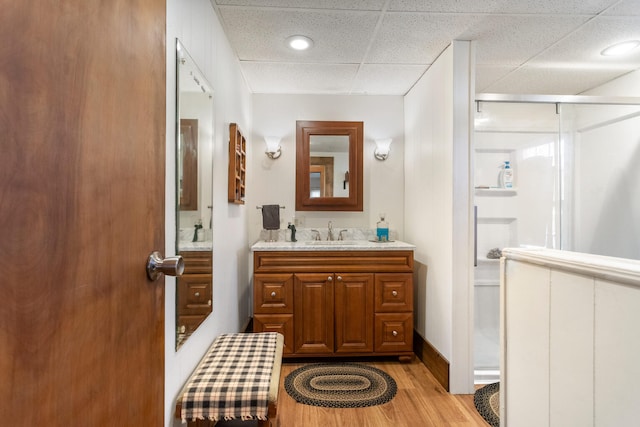 bathroom featuring vanity, wood-type flooring, and a paneled ceiling