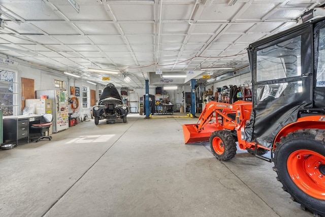 garage with stainless steel fridge