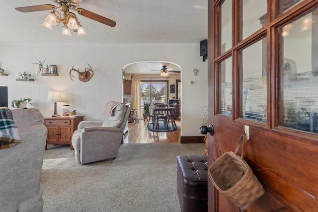 carpeted living room with ceiling fan