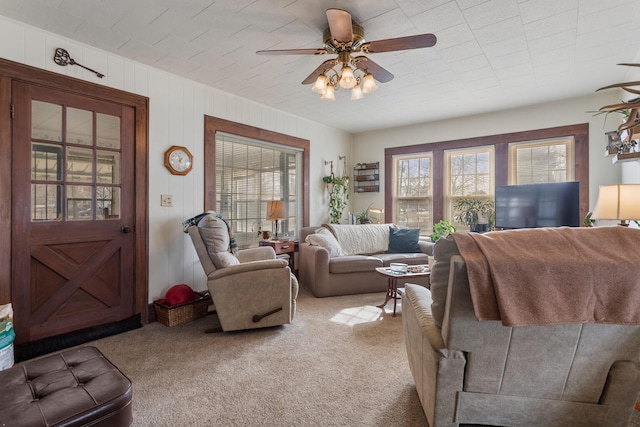 carpeted living room featuring ceiling fan and plenty of natural light