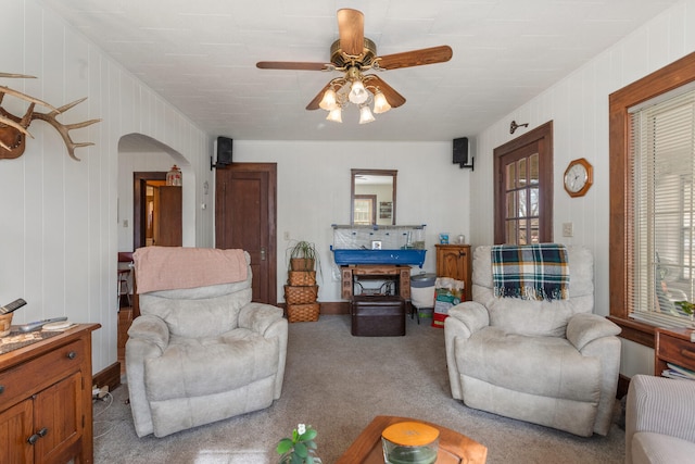 carpeted living room featuring ceiling fan