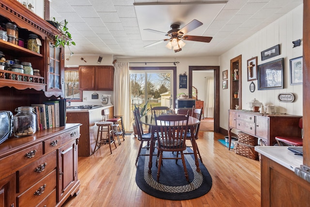 dining room featuring light hardwood / wood-style floors and ceiling fan