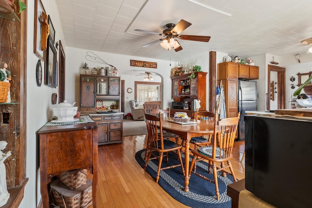 dining room with hardwood / wood-style floors and ceiling fan