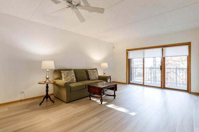 living room with ceiling fan and light wood-type flooring