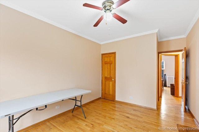 office space with crown molding, ceiling fan, and light wood-type flooring