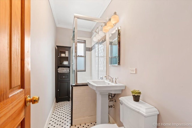 bathroom featuring tile patterned flooring, ornamental molding, and toilet