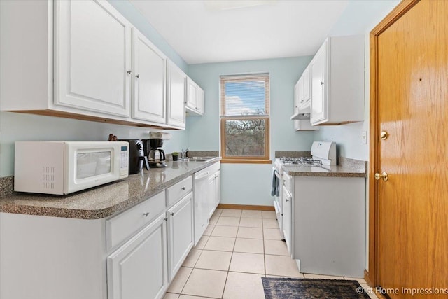 kitchen featuring sink, light tile patterned floors, white cabinets, and white appliances