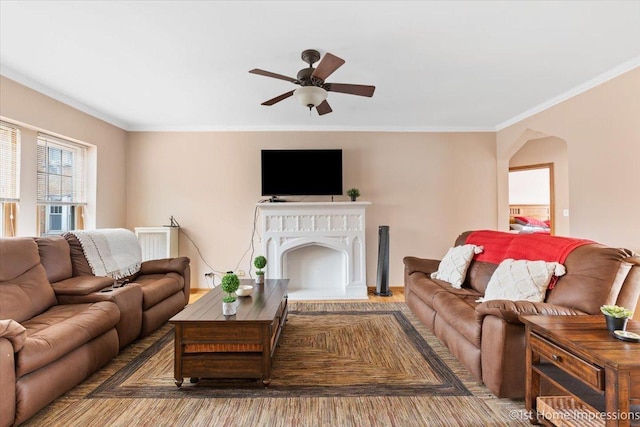 living room with crown molding and ceiling fan