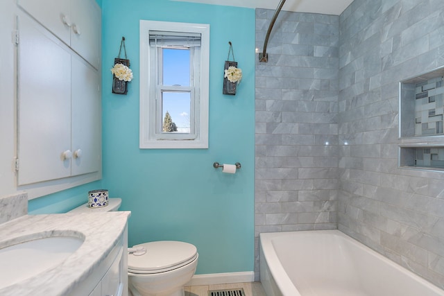 full bathroom with tiled shower / bath, vanity, toilet, and tile patterned flooring