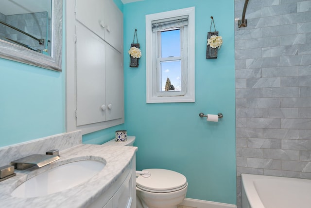 full bathroom featuring vanity, tiled shower / bath, and toilet