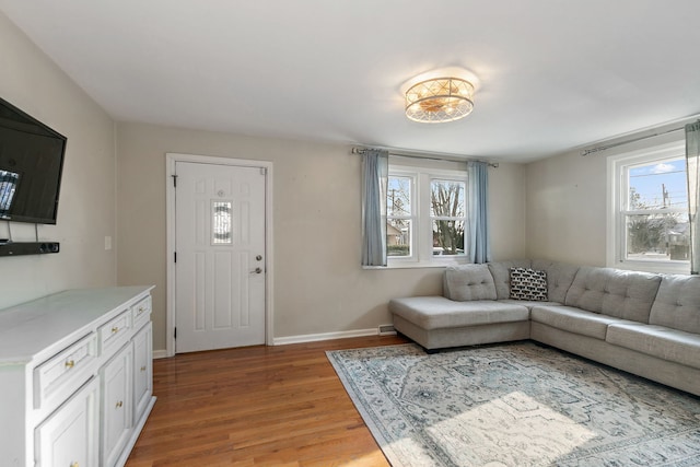 living room with light hardwood / wood-style floors and a healthy amount of sunlight