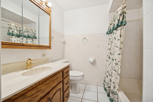 full bathroom with tile walls, toilet, shower / bath combo, vanity, and tile patterned floors