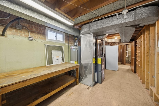 basement featuring freestanding refrigerator and tile patterned floors