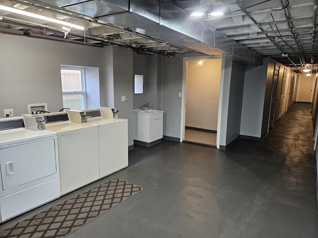 clothes washing area featuring sink and washing machine and dryer